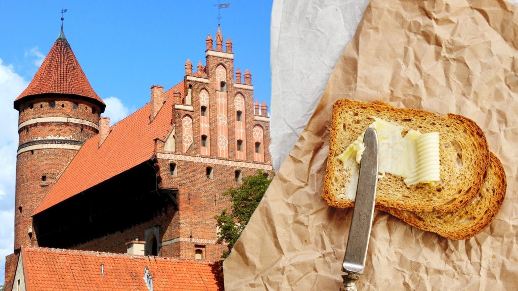 Zamek z czerwonej cegły i kromka chleba z masłem.