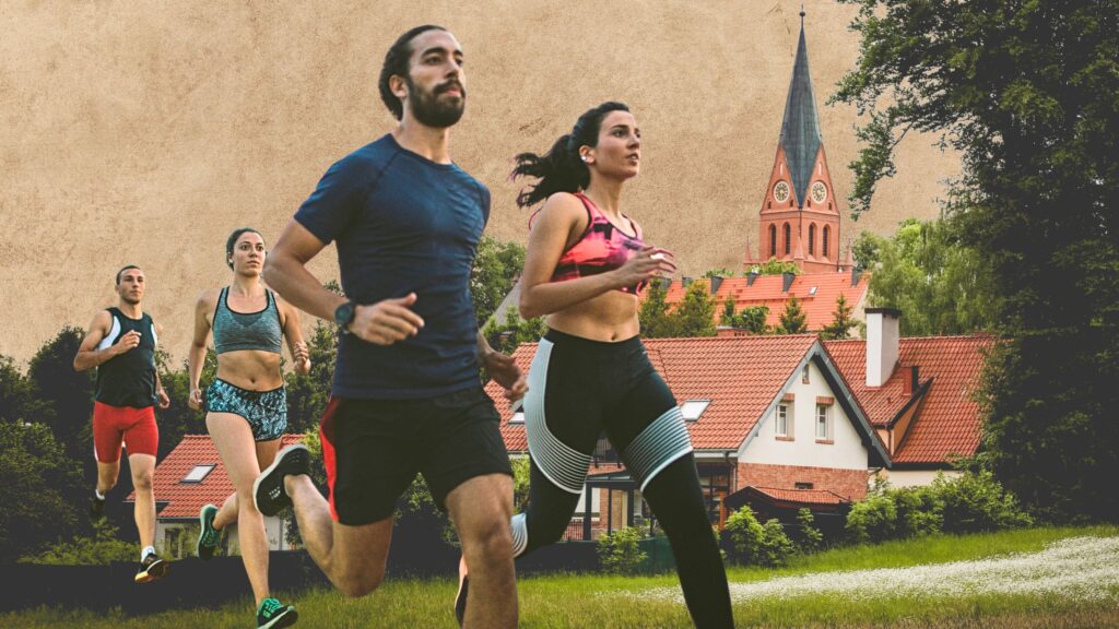 Grupa biegaczy na tle krajobrazu miejskiego.