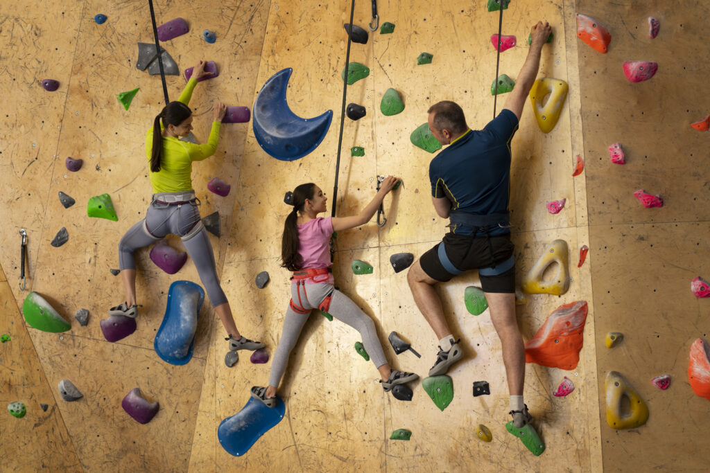 * family-rock-climbing-together-indoors-arena