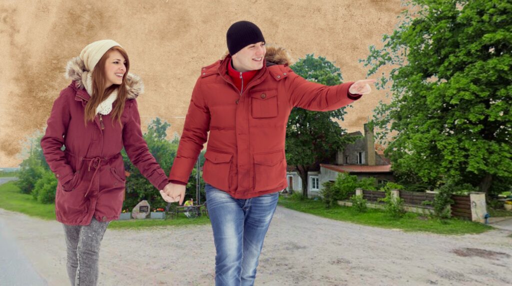 Para idąca ręka w rękę w zimowych kurtkach.