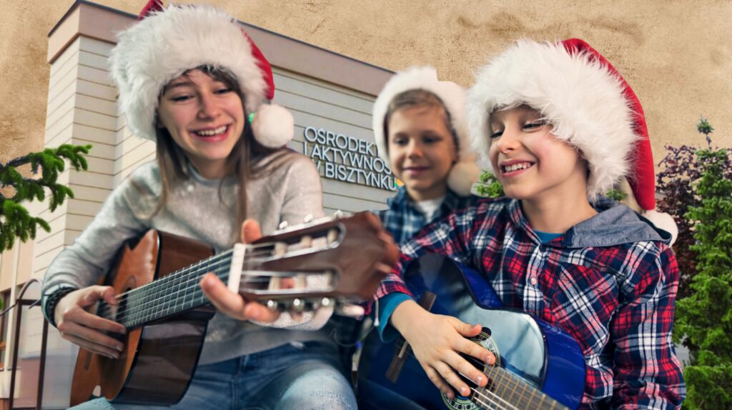 Dzieci grające na gitarze w świątecznych czapkach.