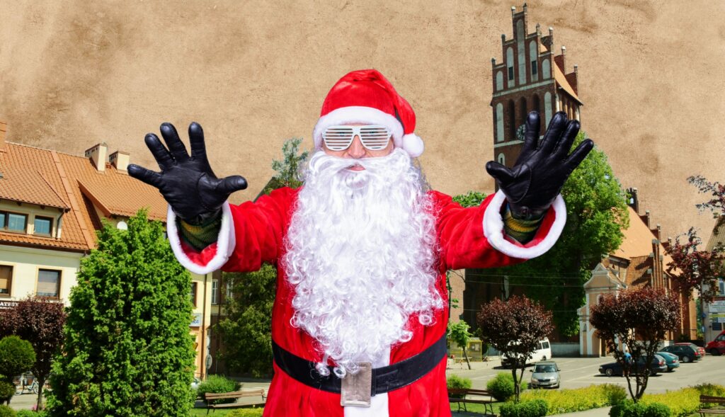 Mikołaj w czerwonym stroju z okularami słonecznymi.