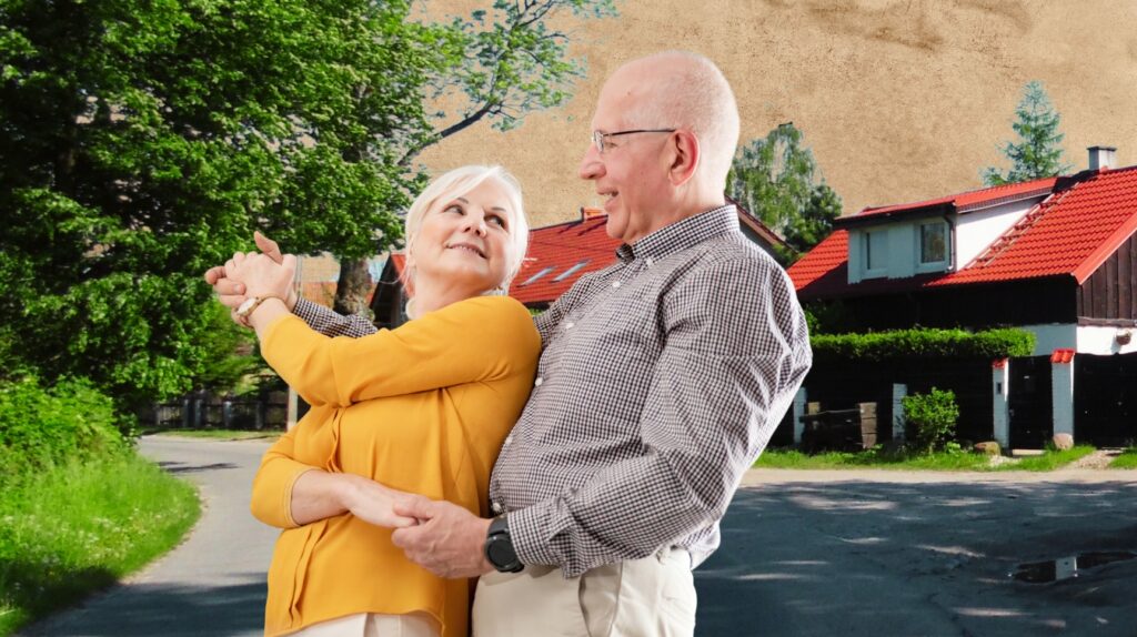 Para w średnim wieku na tle domów.