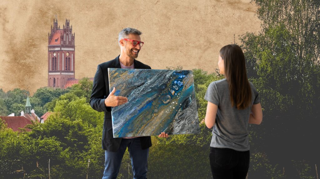 Mężczyzna pokazuje obraz kobiecie przed wieżą.
