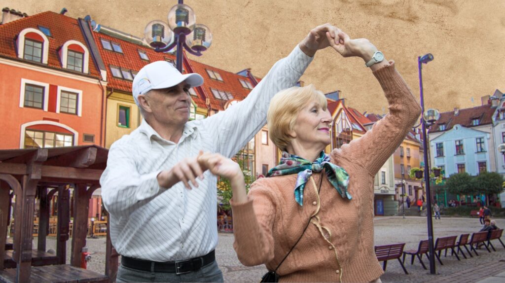 Para tańcząca na tle kolorowych budynków.