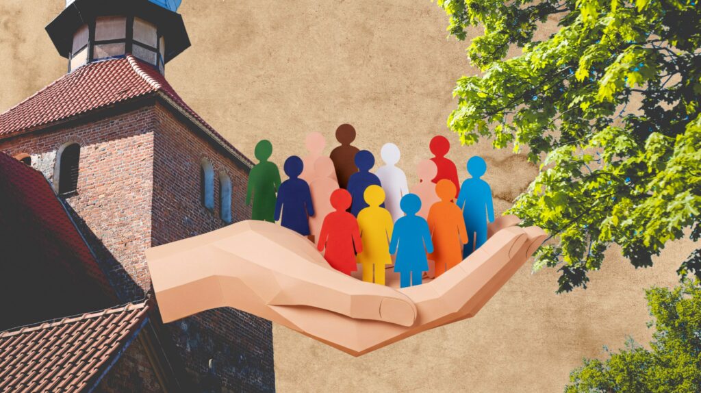 Papierowa figura w dłoni przy budynku.