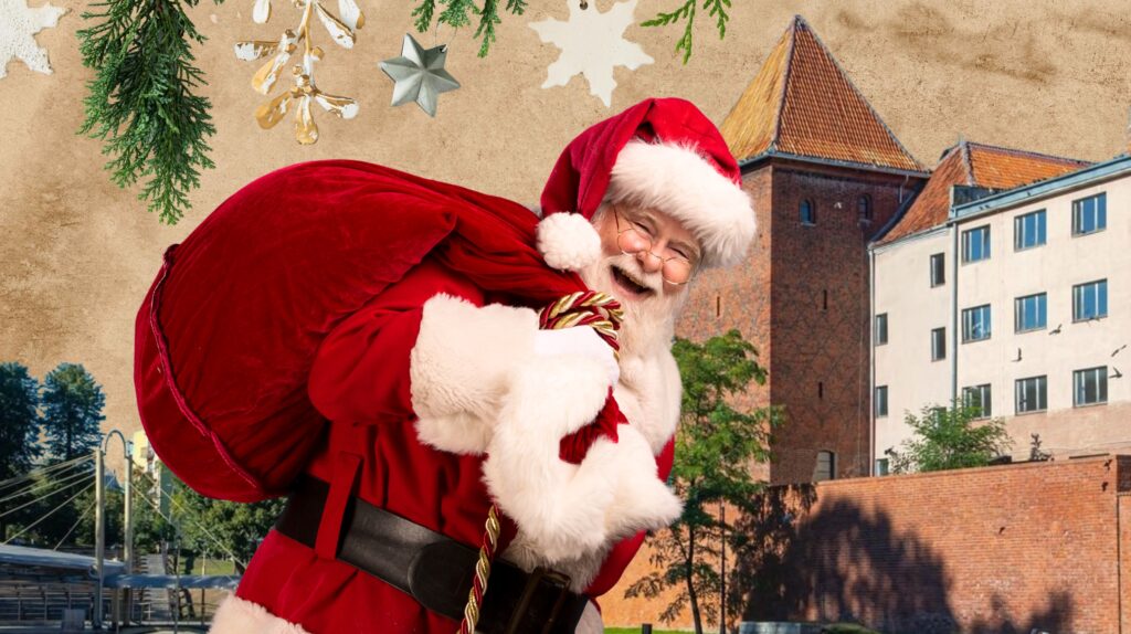 Święty Mikołaj niesie worek prezentów.