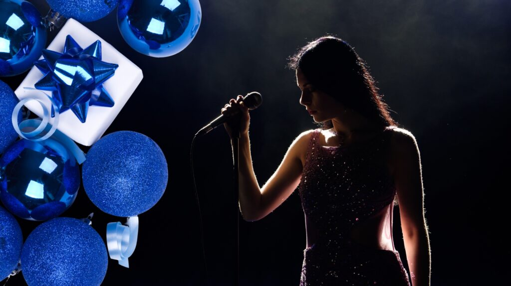 Silhouette of a singer with a microphone against a dark background and blue decorative elements.