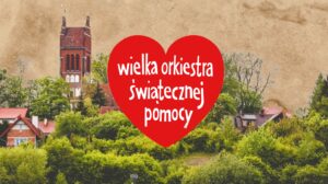 Widok na zielone tereny z czerwoną reklamą WOŚP.