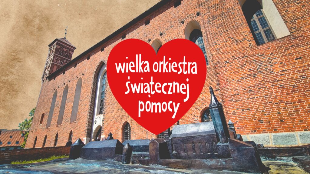 Widok na budynek z hasłem Wielkiej Orkiestry Świątecznej Pomocy.