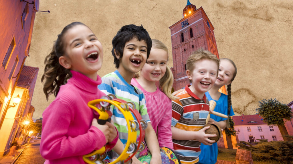 Grupa dzieci bawiących się na ulicy.