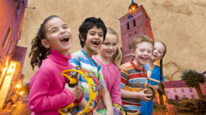 Grupa dzieci bawiących się na ulicy.