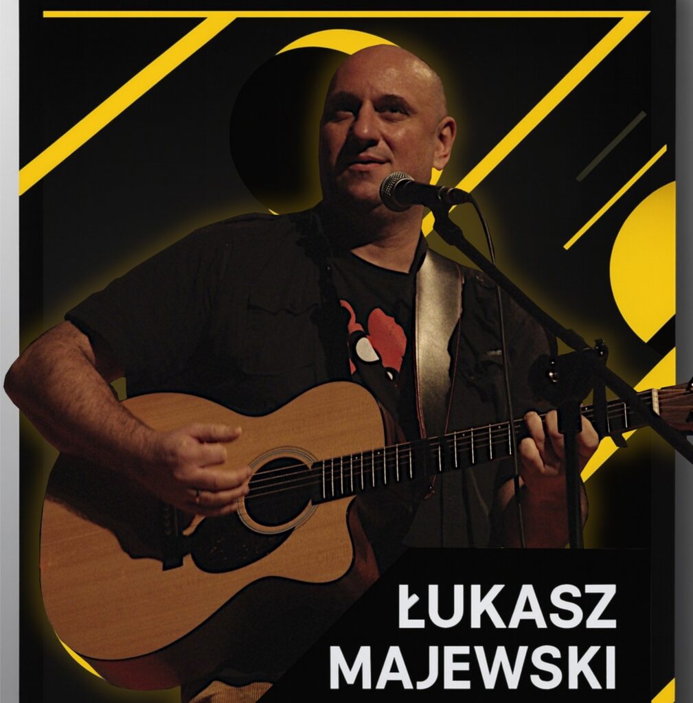 Mężczyzna grający na gitarze akustycznej.