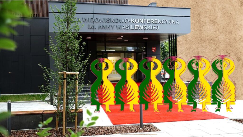 Wewnętrzny korytarz budynku z czerwonym dywanem i rzeźbami.