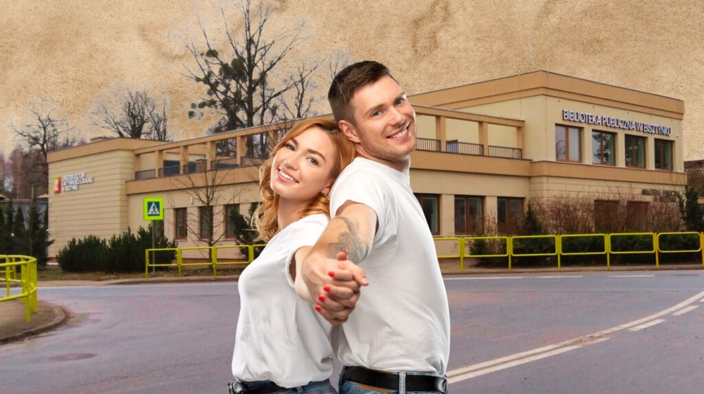 Młoda para stoi tyłem do siebie przed budynkiem biblioteki.