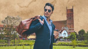 Mężczyzna w garniturze z torbą i kawą