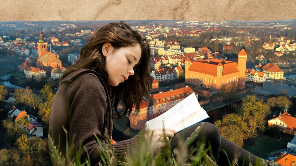 Dziecko czyta książkę z widokiem na miasto