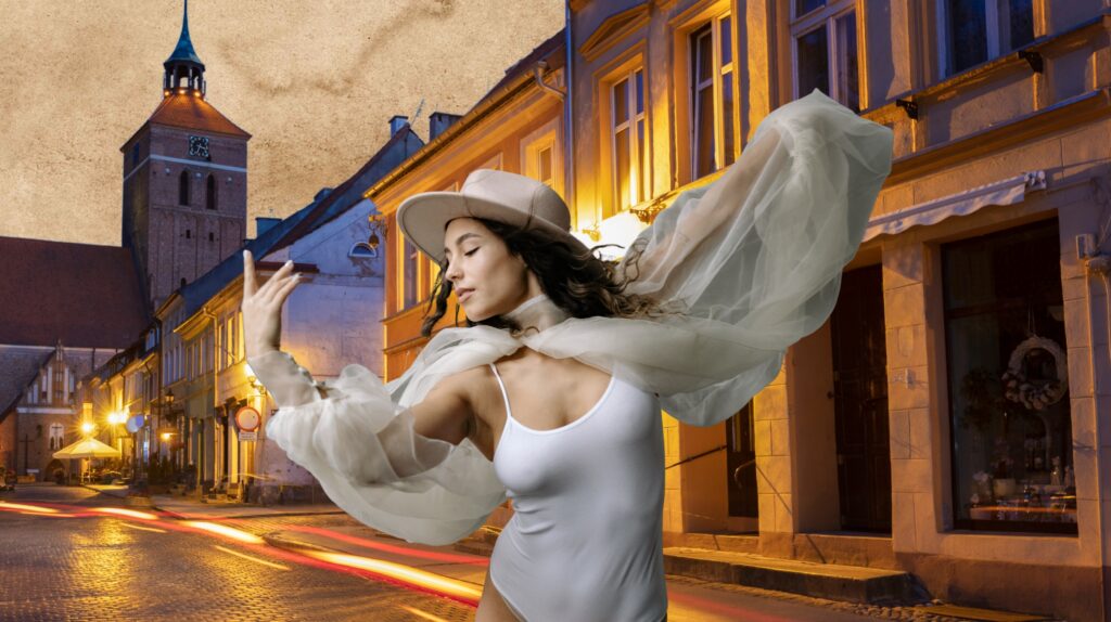 Tancerka w białym stroju na tle ulicy