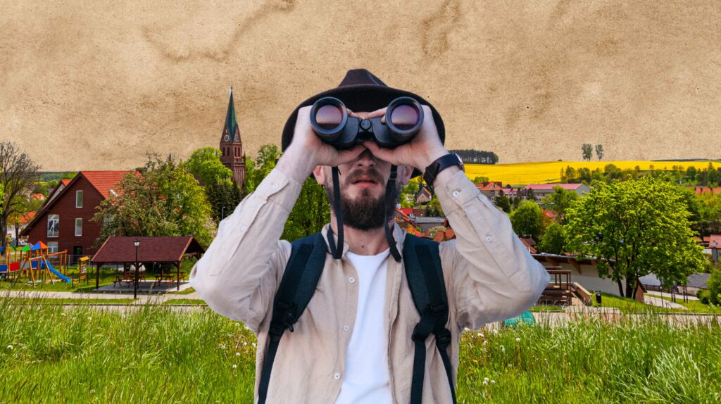 Mężczyzna obserwujący widok przez lornetkę.