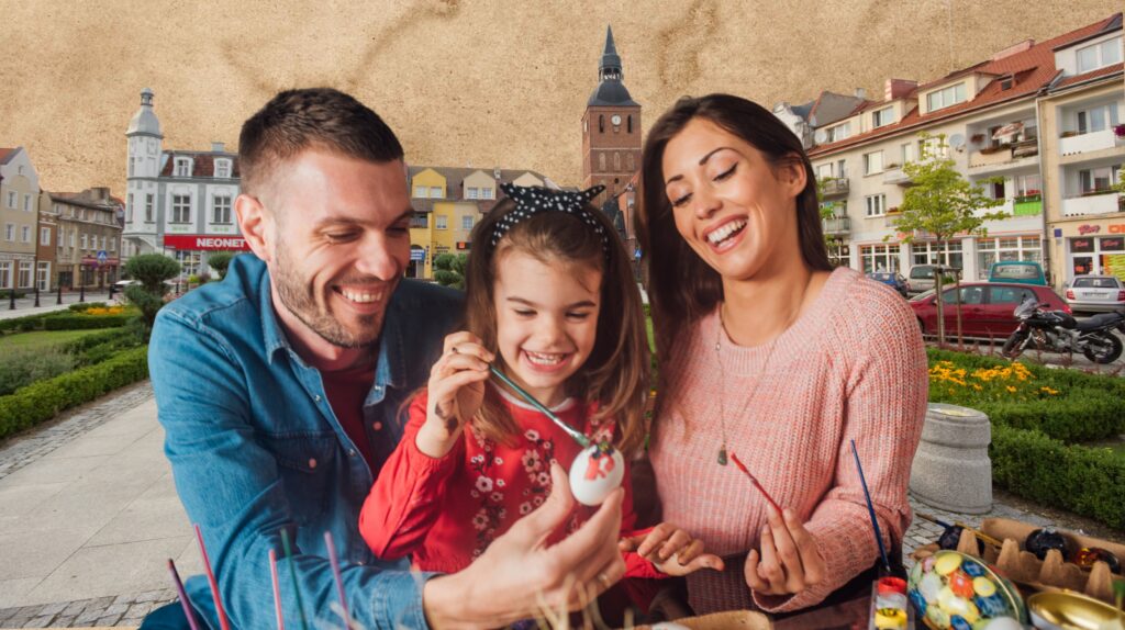 Rodzina maluje pisanki na zewnątrz.