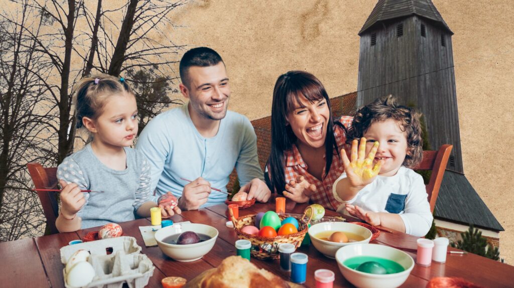 Rodzina maluje pisanki przy stole.