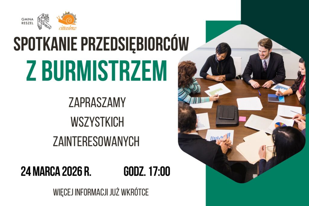 Spotkanie przedsiębiorców z burmistrzem przy stole.
