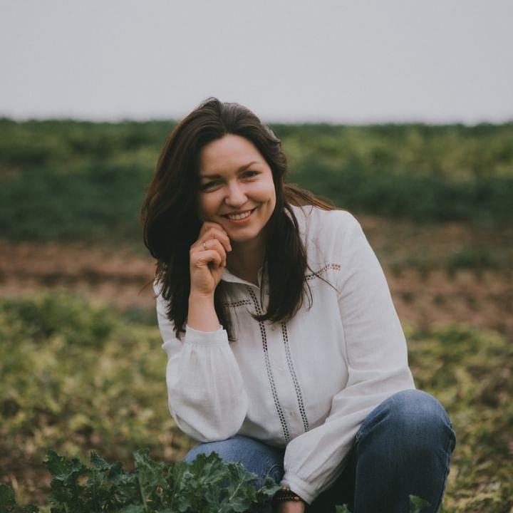 Kobieta uśmiechająca się na polu.