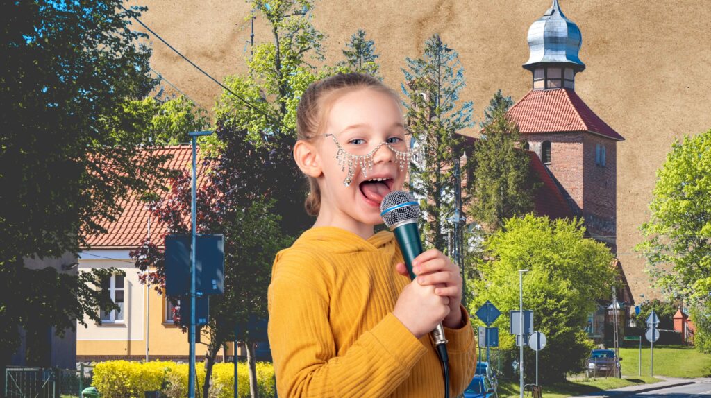 Dziewczynka trzymająca mikrofon, uśmiechająca się.