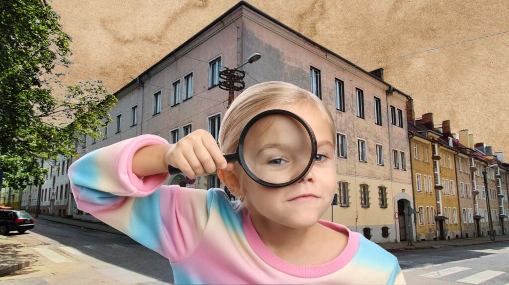 Dziewczynka trzymająca lupę na tle ulicy.