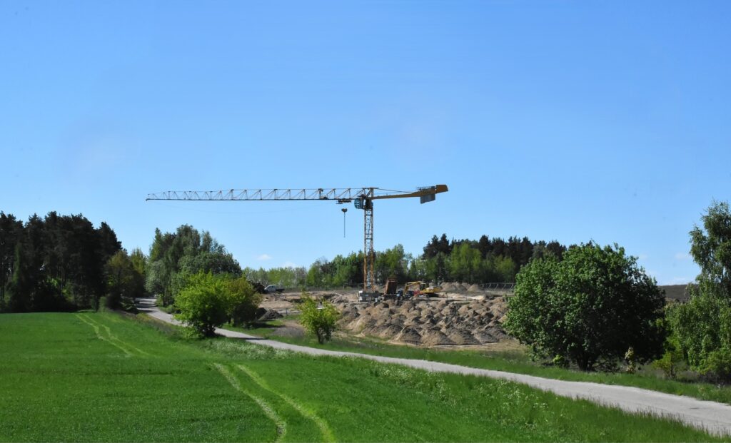 Widok na żurawia budowlanego na placu budowy.
