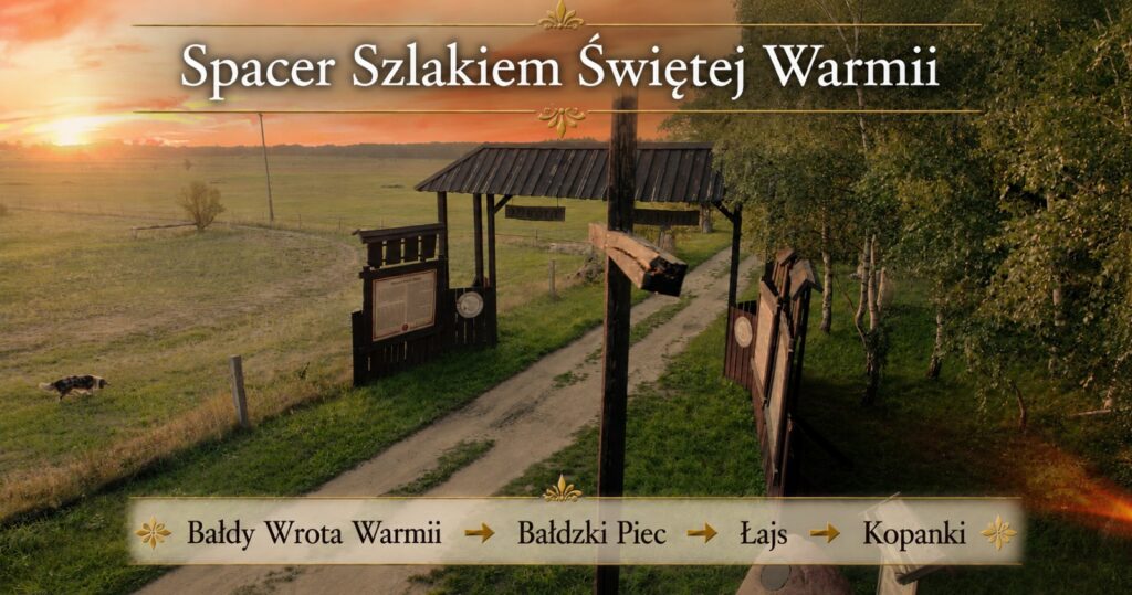 Droga prowadząca przez zielony krajobraz Warmii z tablicami informacyjnymi.