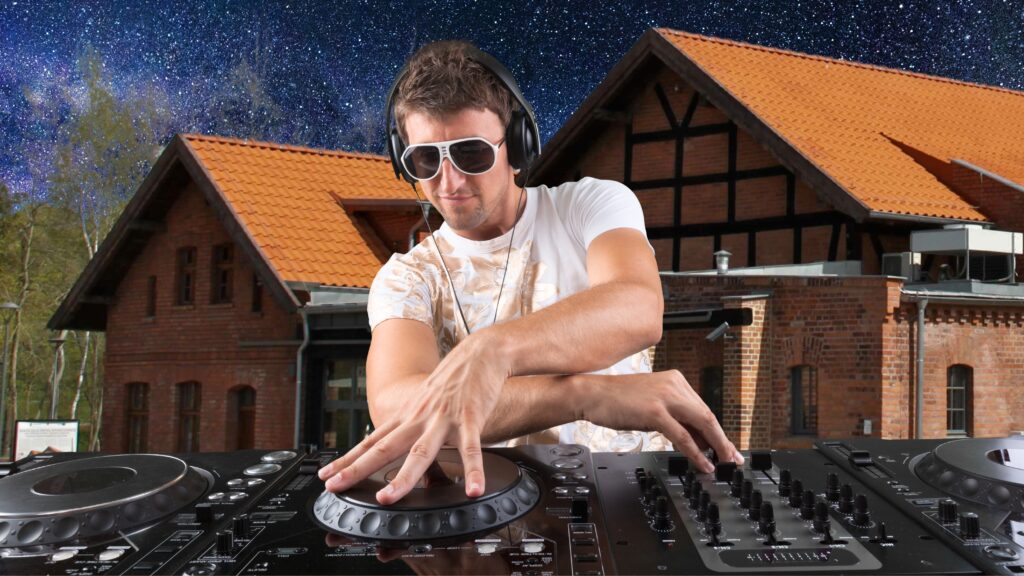 DJ grający na konsoli z obiektami w tle