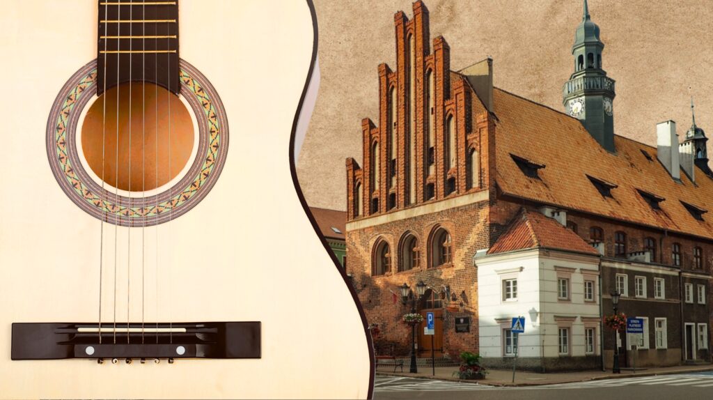Guitar neck beside a historic building.