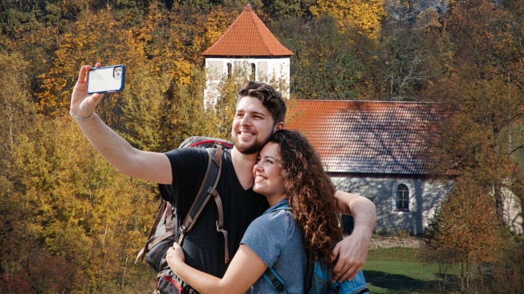 Para robiąca selfie w plenerze