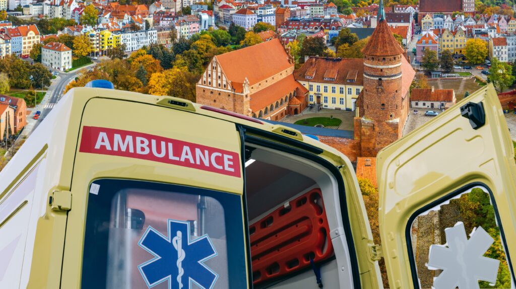 Otwarte drzwi karetki z widokiem na miasto