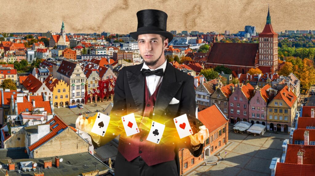 Mężczyzna w kapeluszu cylindrycznym trzyma karty w magicznej pozie.