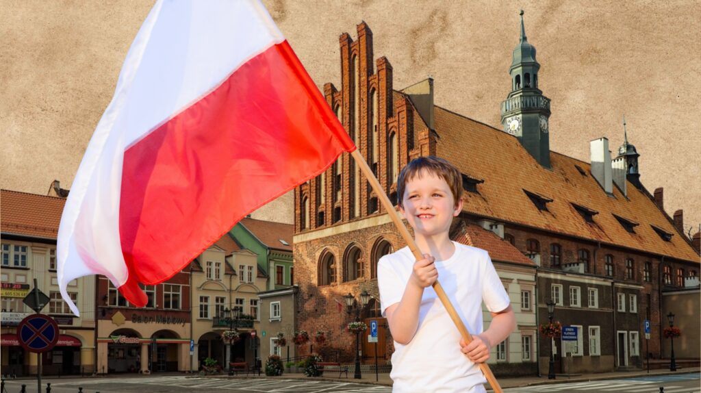 Chłopiec trzymający flagę Polski na tle miasta.